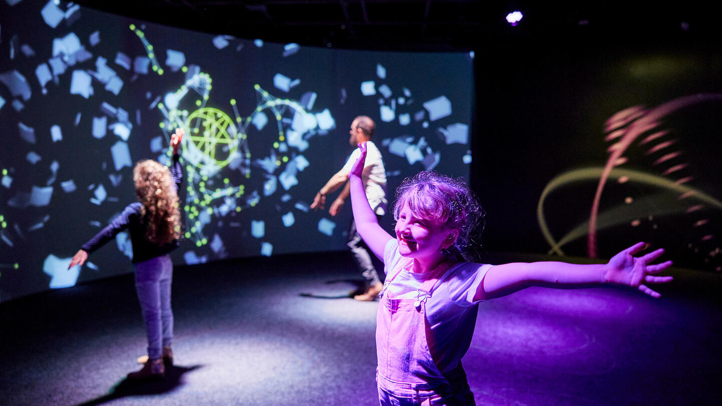 Photo of a smiling child at the exhibit at the Sydney Opera House