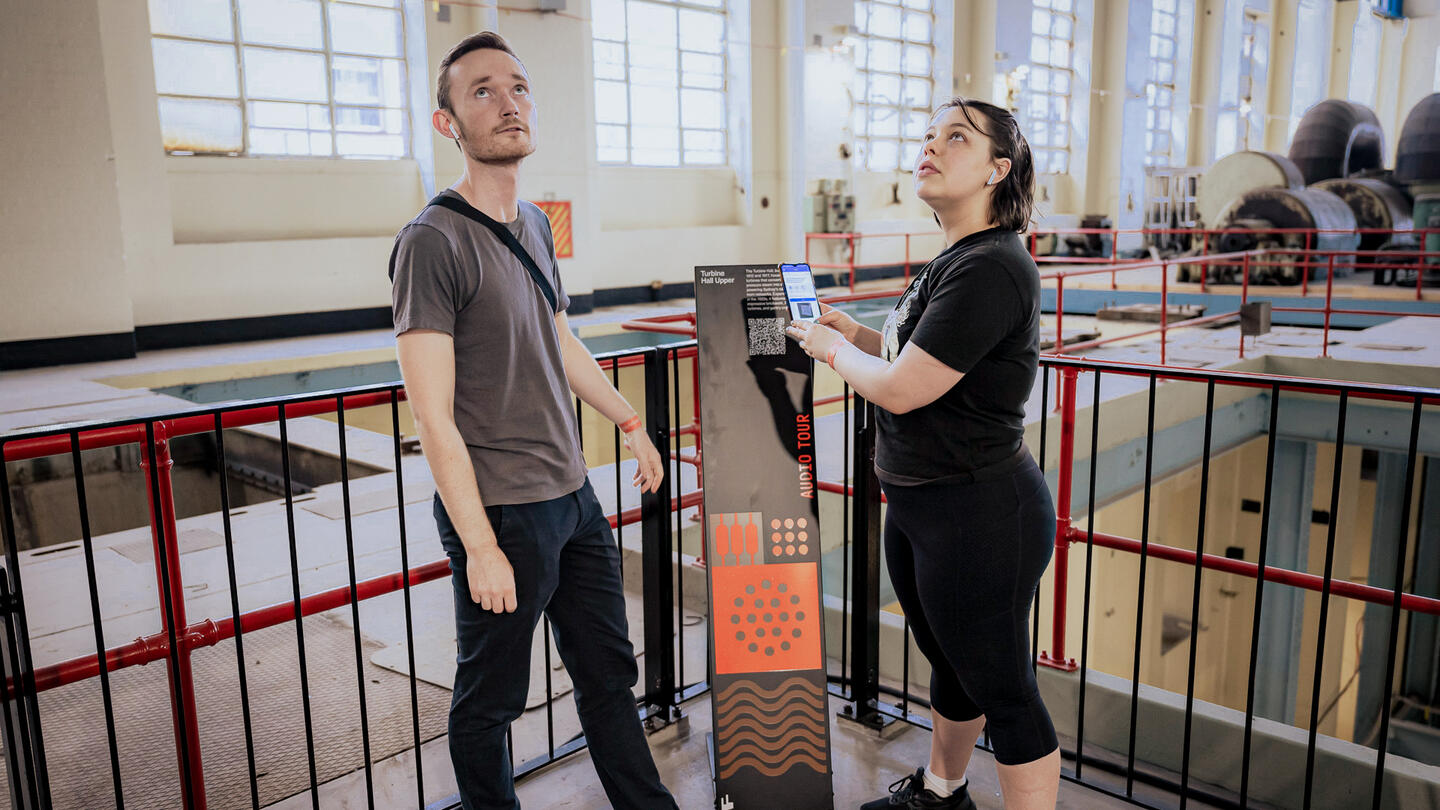 Two visitors interacting with exhibit at White Bay Power Station